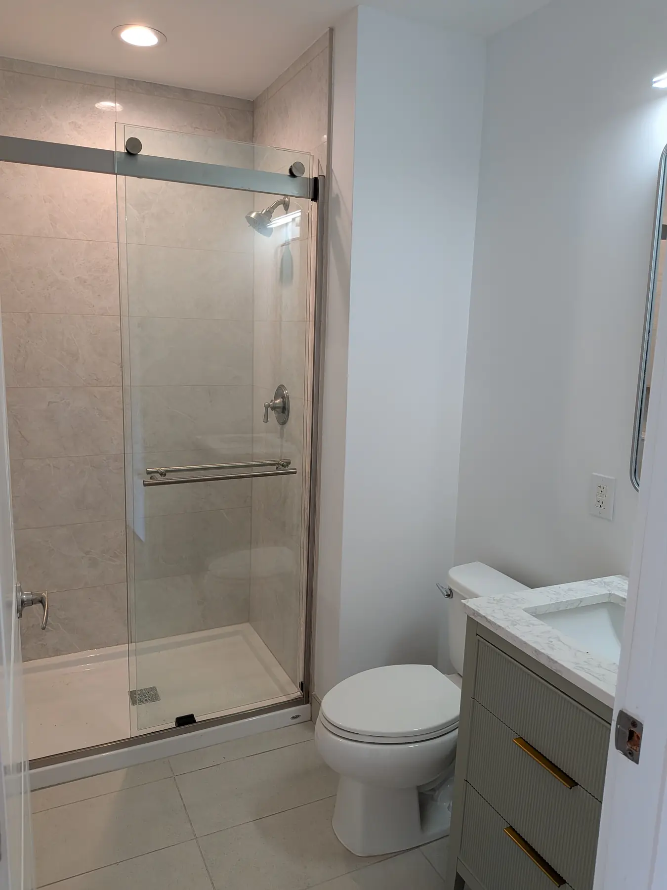 The walk-in shower and vanity in the finished second bathroom