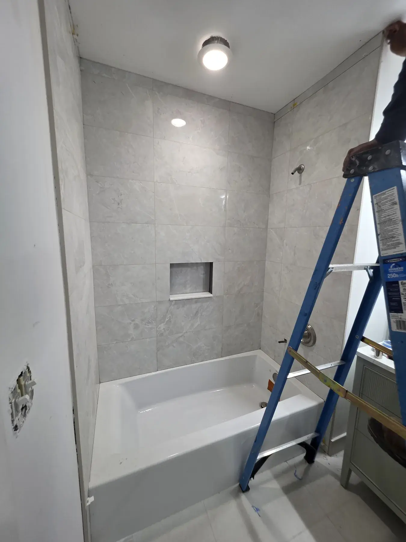 The tiled tub surround part-way through installation