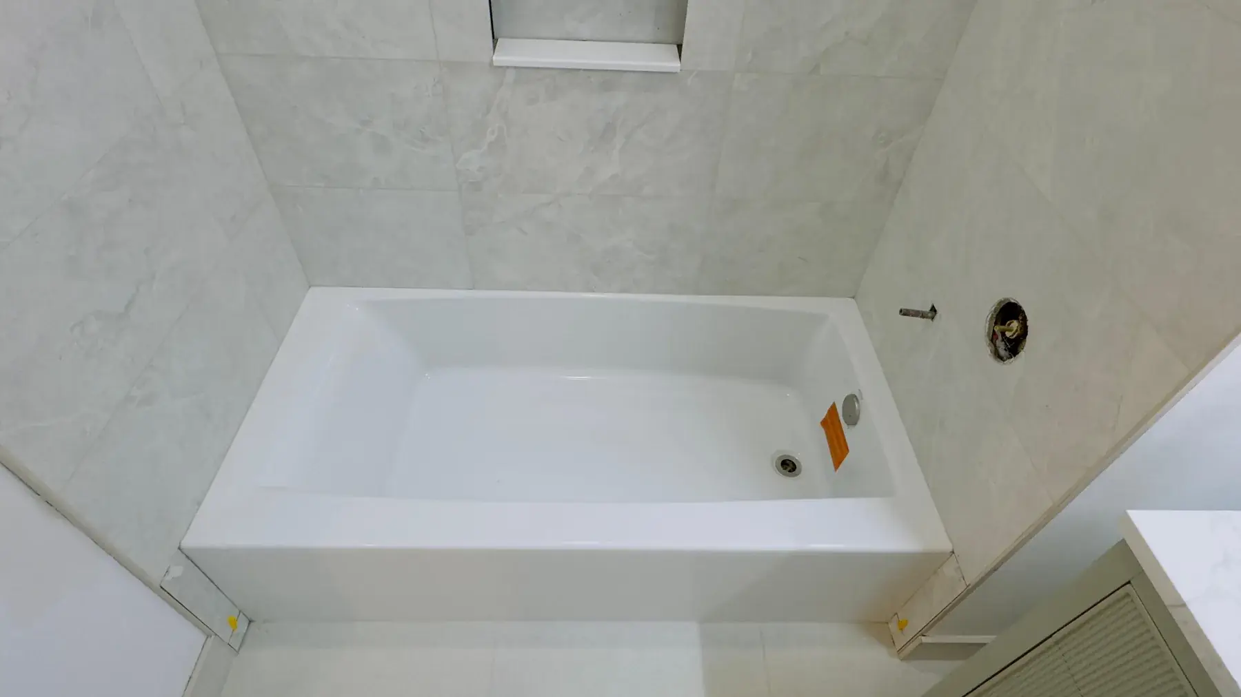 The new tub in place beneath the finished tile surround