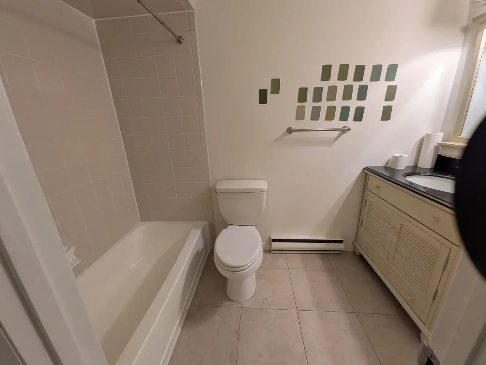 The original bathroom with its tub and dated vanity, before conversion