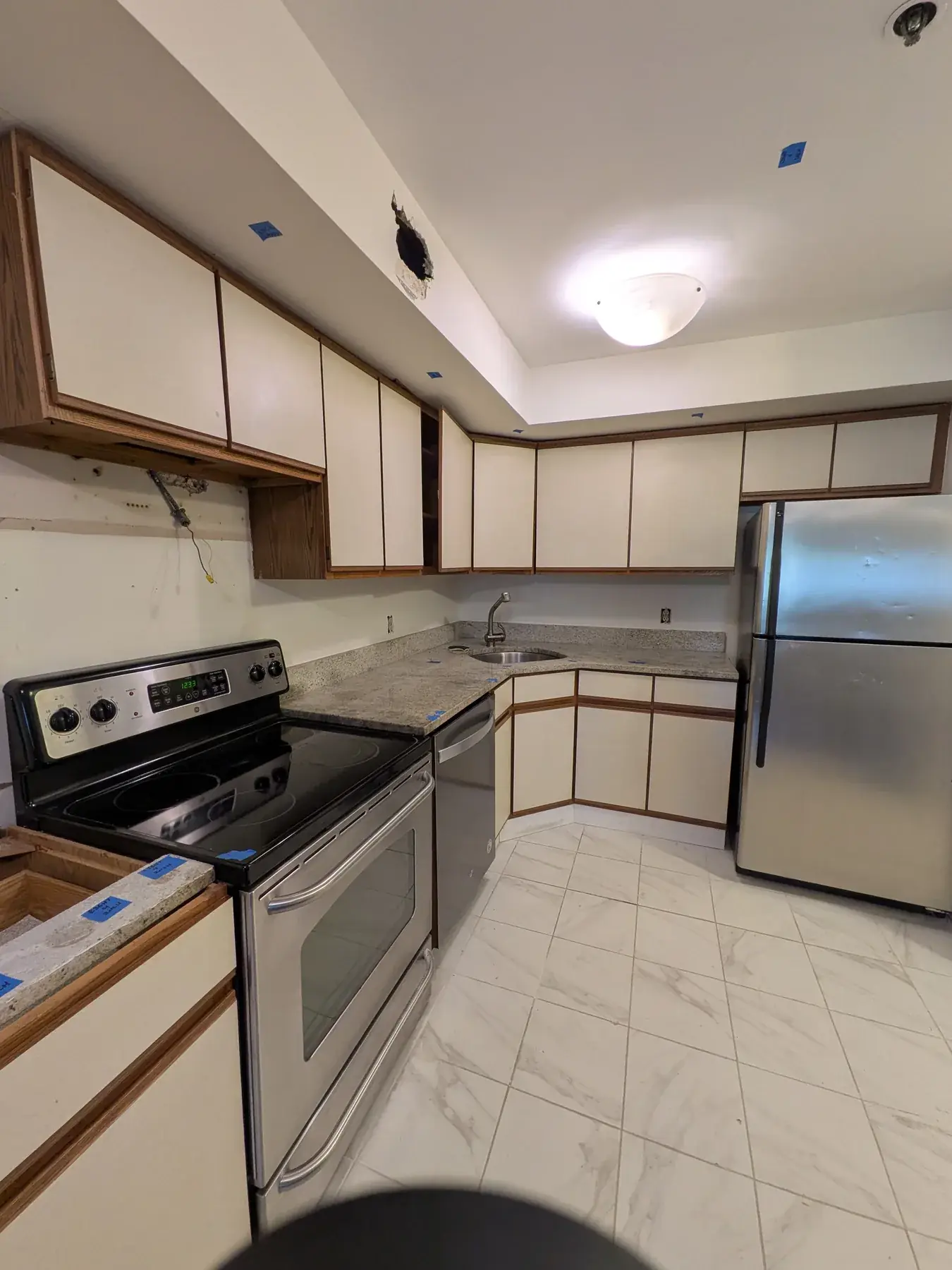 The original kitchen before work began, with dated cabinets and worktops