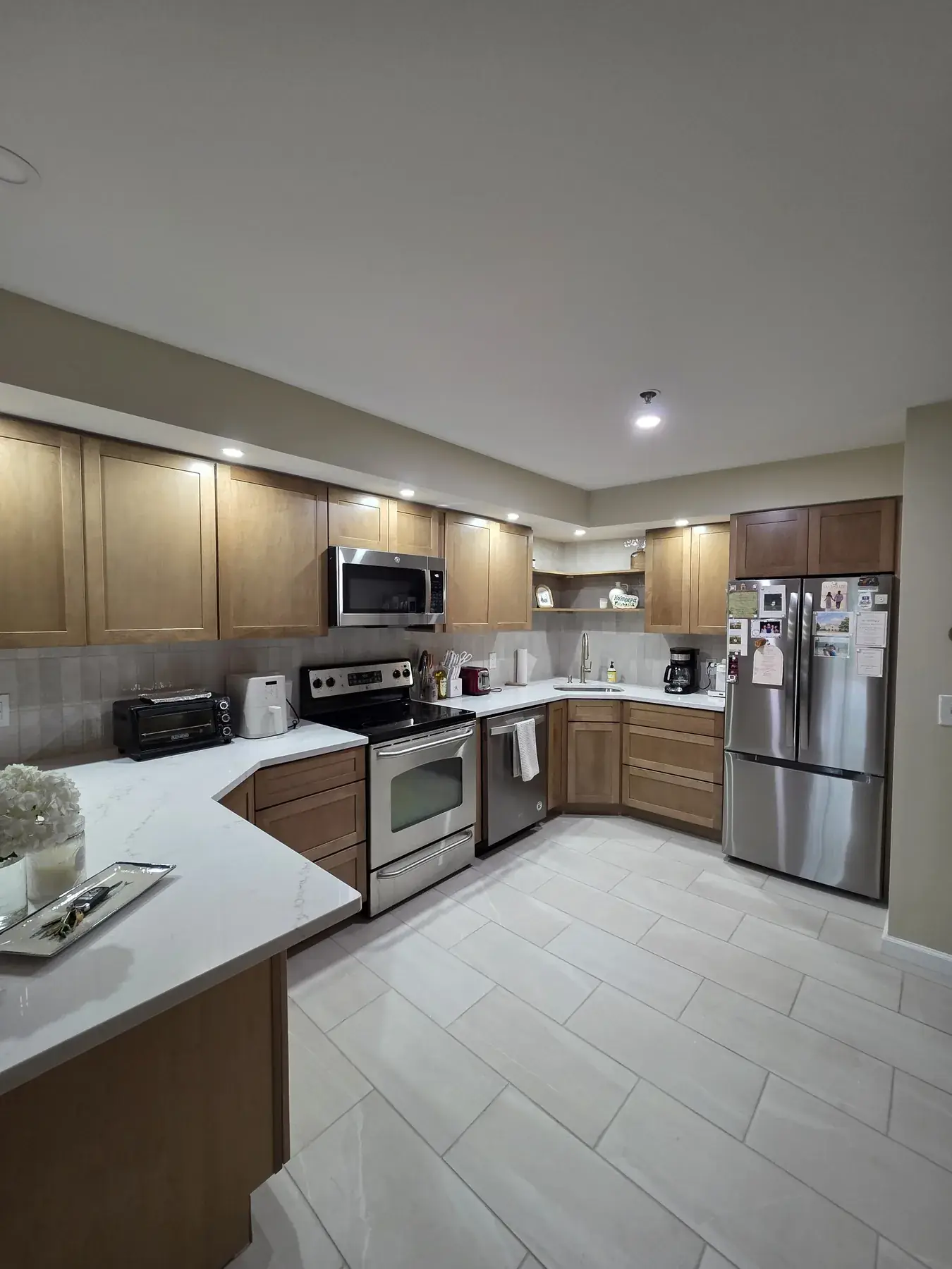 The completed kitchen with new cabinetry, stone worktops and stainless appliances