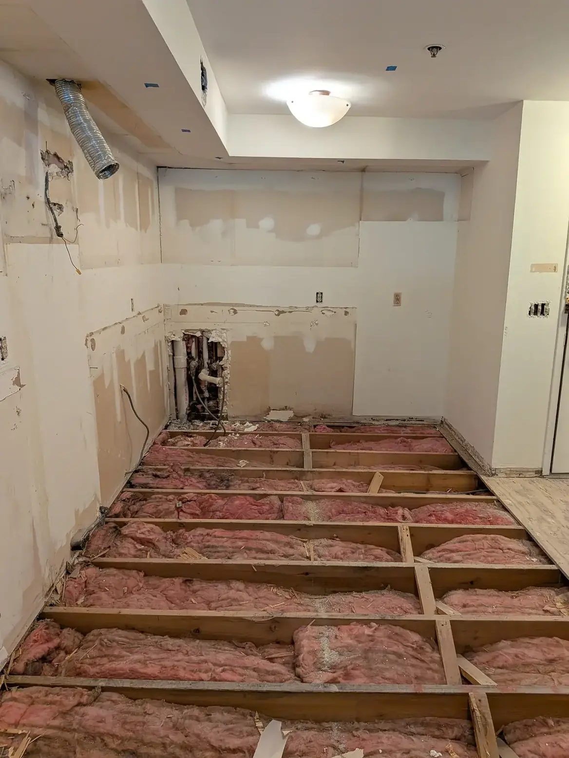 The floor taken back to the joists across the kitchen before levelling