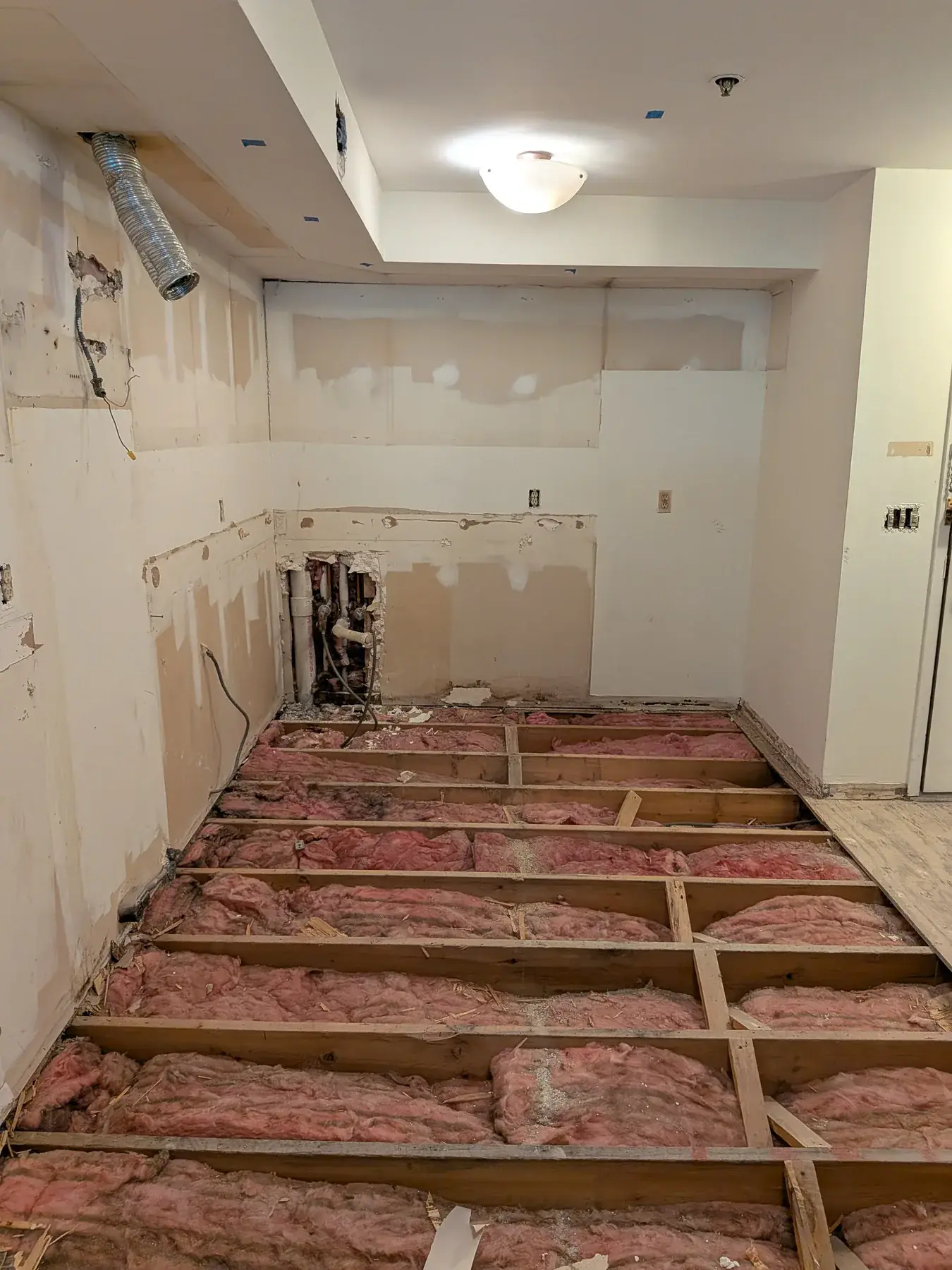 The floor taken back to the joists across the kitchen before levelling