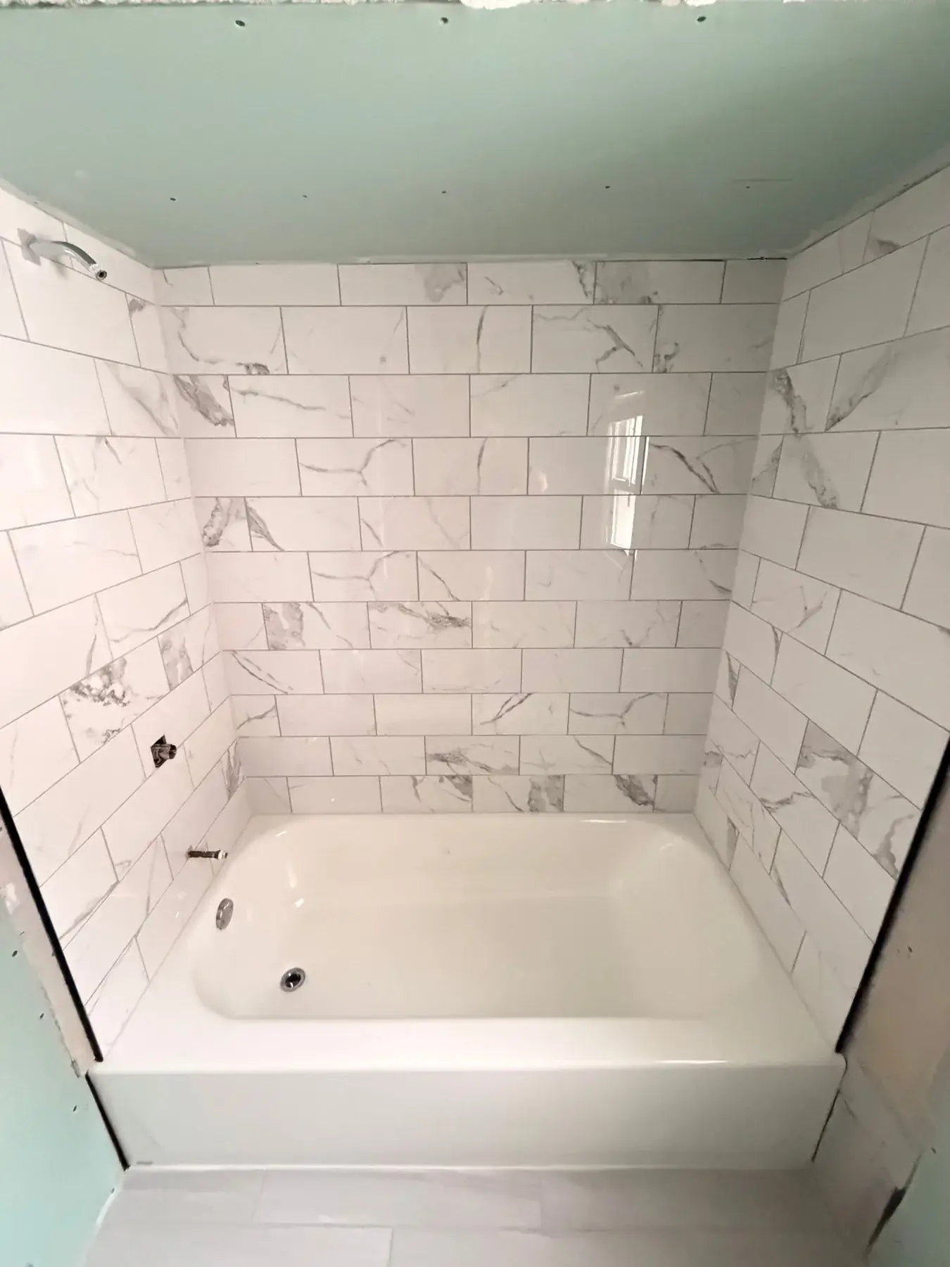 The completed tile surround and new tub, seen straight on