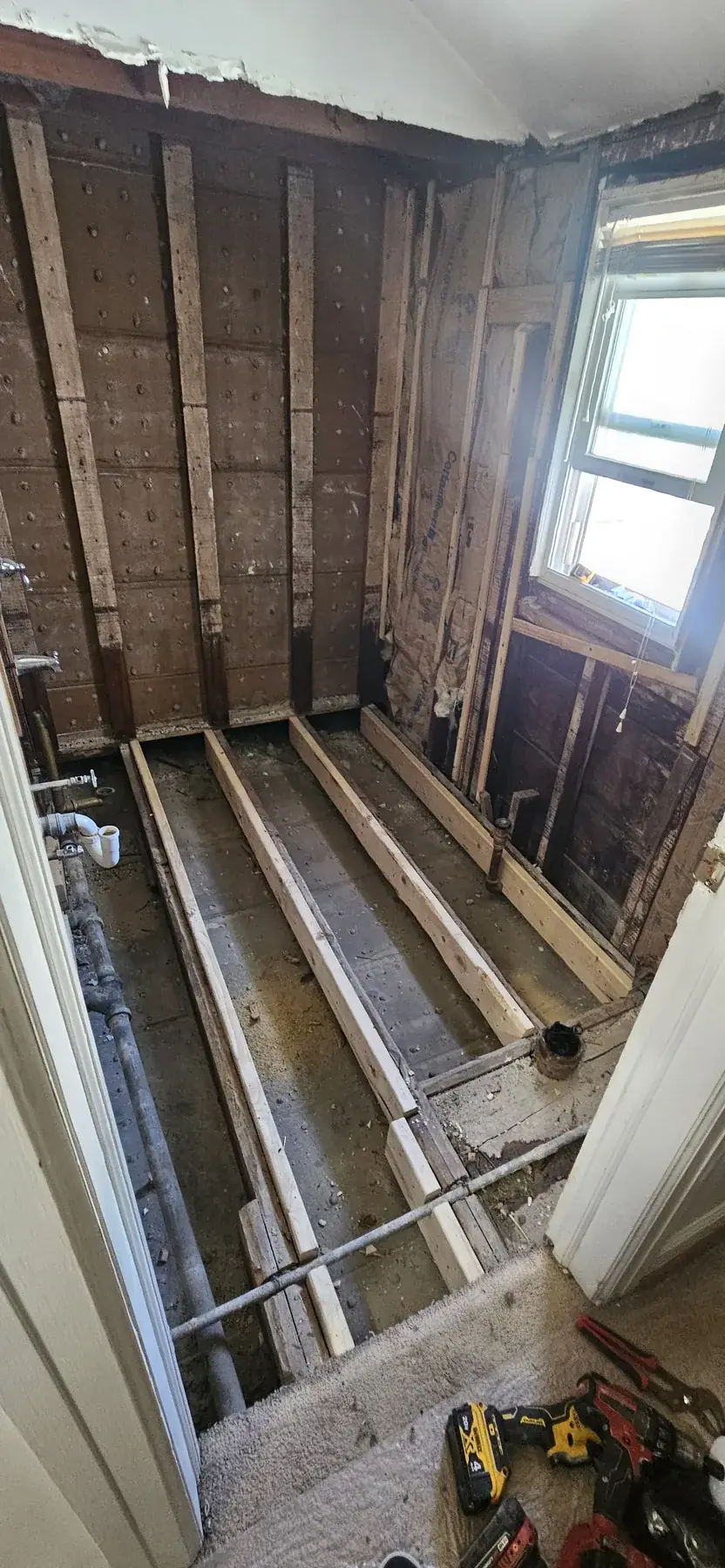 New floor framing and a reframed window opening, before the walls were closed